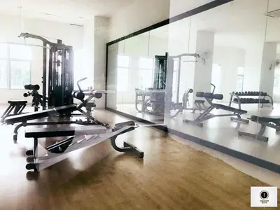 a gym with several tread machines and a large mirror at Taiping Homestay in Taiping