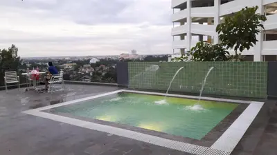 a swimming pool on the roof of a building at Taiping Homestay in Taiping