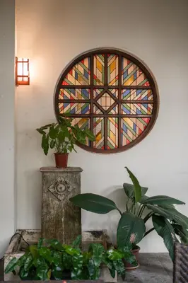 a stained glass window in a room with plants at Hotel Penaga in George Town