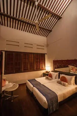 a large bedroom with a large bed and a chair at Hotel Penaga in George Town