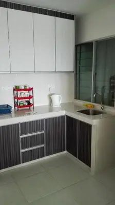 a kitchen with white cabinets and a sink at Sekinchan SeaBreeze Homestay \u9002\u8015\u5e84\u6d77\u98ce\u5439\u6c11\u5bbf in Sekincan