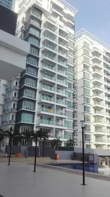 a large white apartment building with palm trees in front of it at Sekinchan SeaBreeze Homestay \u9002\u8015\u5e84\u6d77\u98ce\u5439\u6c11\u5bbf in Sekincan