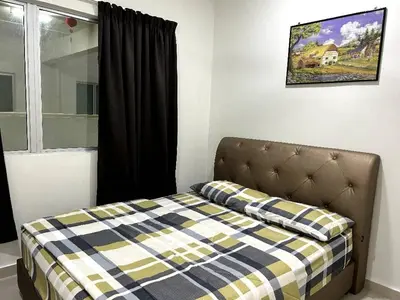 a bed with a checkered blanket in a bedroom at Sekinchan SeaBreeze Homestay \u9002\u8015\u5e84\u6d77\u98ce\u5439\u6c11\u5bbf in Sekincan