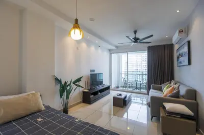 a living room with a couch and a tv at Sky Suites in George Town