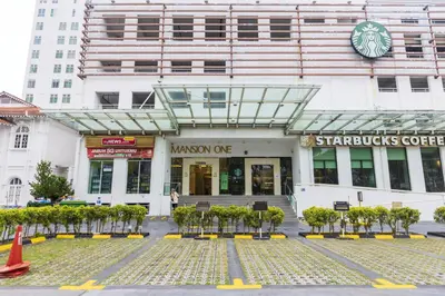 a building with a walkway in front of a store at Sky Suites in George Town