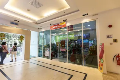 a store entrance with people walking into a store at Sky Suites in George Town