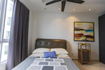 a bedroom with a bed with a ceiling fan at Sky Suites in George Town