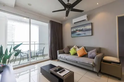 a living room with a couch and a large window at Sky Suites in George Town