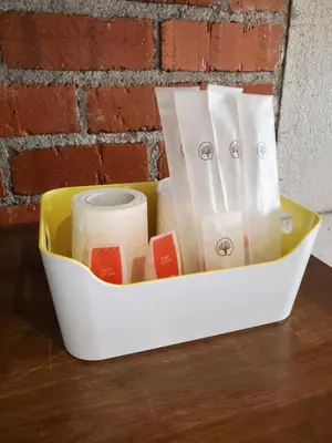 a container filled with toilet paper sitting on a table at Little Kampung Studio in Teluk Intan