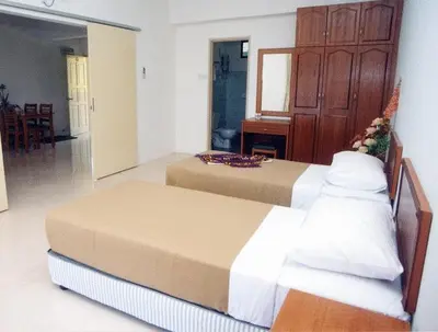 a bedroom with two beds in a room at Marina Cove Resort in Lumut