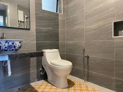 a bathroom with a toilet and a sink at Lumut Valley Condominium in Lumut