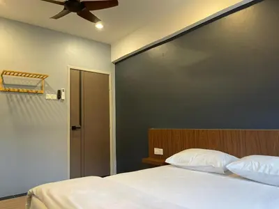 a bedroom with a bed and a ceiling fan at Lumut Valley Condominium in Lumut