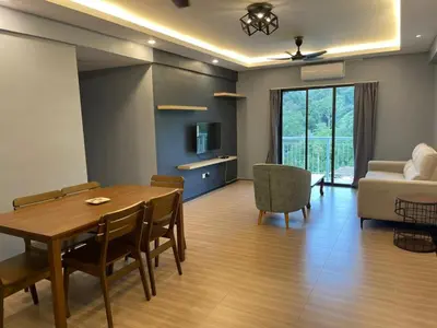 a living room with a table and a couch at Lumut Valley Condominium in Lumut