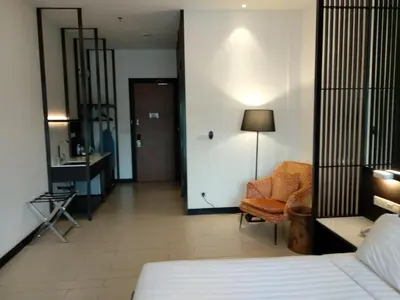 a bedroom with a bed and a chair and a desk at Avillion Cameron Highlands in Cameron Highlands