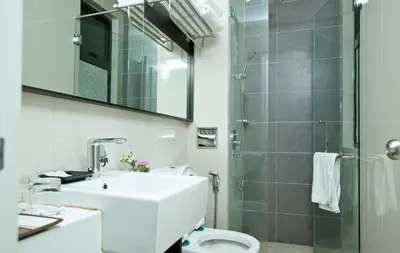a bathroom with a toilet and a sink and a shower at Avillion Cameron Highlands in Cameron Highlands