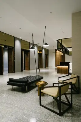 a lobby with a couch and chairs in a building at Avillion Cameron Highlands in Cameron Highlands