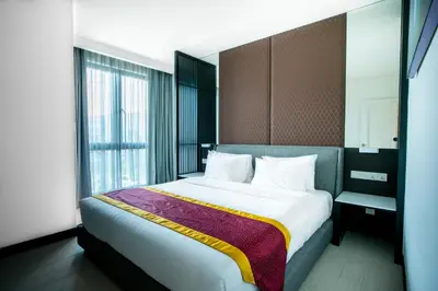 a bedroom with a large bed and a window at Avillion Cameron Highlands in Cameron Highlands