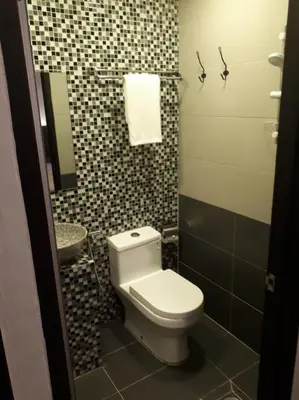 a small bathroom with a toilet and a sink at Cute Hotel & Dorms Ipoh in Ipoh