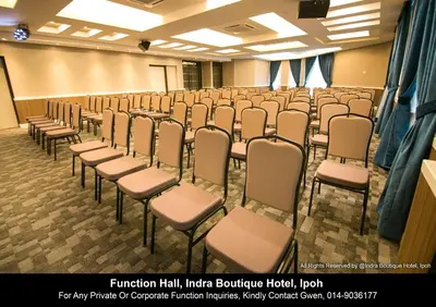 a room with rows of chairs in a classroom at INDRA HOTEL - BOUTIQUE SUITES in Ipoh