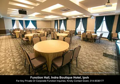 a large room with tables and chairs in it at INDRA HOTEL - BOUTIQUE SUITES in Ipoh