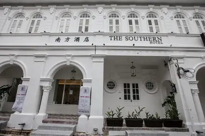 a white building with a sign for the southern hotel at The Southern Boutique Hotel in George Town