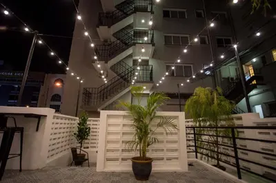 a building with a white fence and plants and lights at The Southern Boutique Hotel in George Town