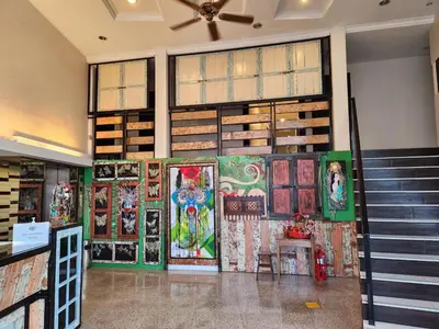 a room with paintings on the wall and stairs at Fair Park Hotel in Ipoh