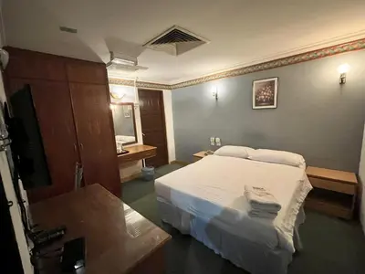 a hotel room with a bed and a television at Fair Park Hotel in Ipoh