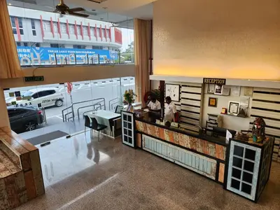 two people standing at the counter of a restaurant at Fair Park Hotel in Ipoh