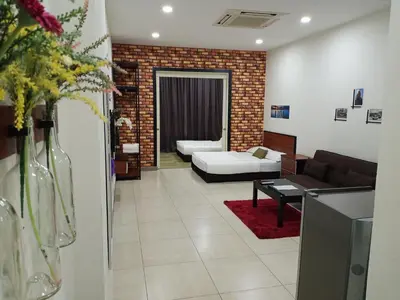 a living room with a couch and a table at The Octagon Ipoh - Home Stay in Ipoh
