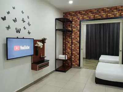a living room with a tv and a bedroom at The Octagon Ipoh - Home Stay in Ipoh