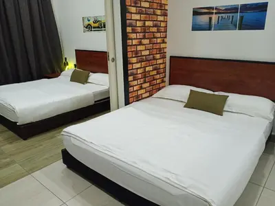 a bedroom with two beds and a brick wall at The Octagon Ipoh - Home Stay in Ipoh