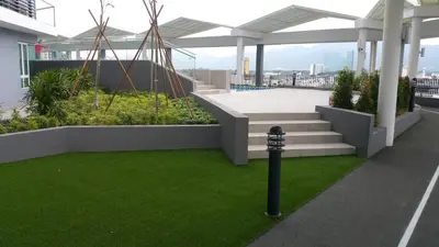 a balcony with stairs and green grass on a building at The Octagon Ipoh - Home Stay in Ipoh