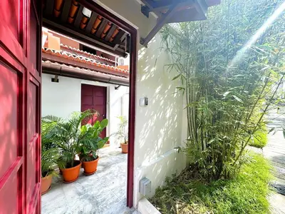 an open door of a house with plants on the side at Yeng Keng Hotel in George Town