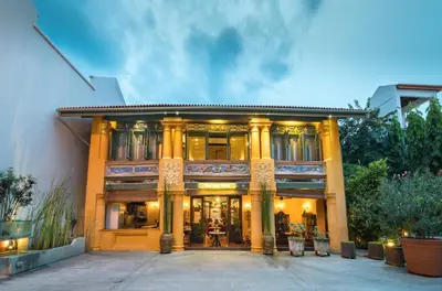 a large building with columns in front of it at Yeng Keng Hotel in George Town