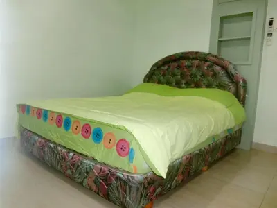 a bed in a room with a bed with donuts on it at Shuang Yang Sekinchan Homestay 6 in Sekincan