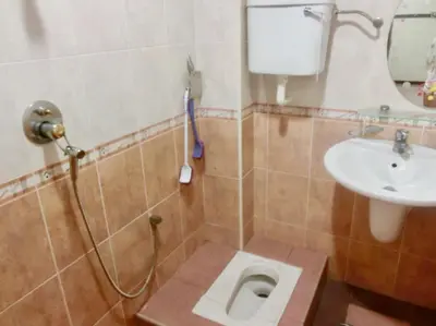 a bathroom with a toilet and a sink at Shuang Yang Sekinchan Homestay 7 in Sekincan