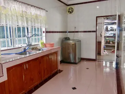 a kitchen with a sink and a window and a refrigerator at Shuang Yang Sekinchan Homestay 7 in Sekincan