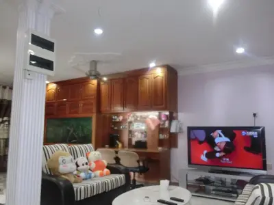 a living room with couches and a flat screen tv at Shuang Yang Sekinchan Homestay 7 in Sekincan