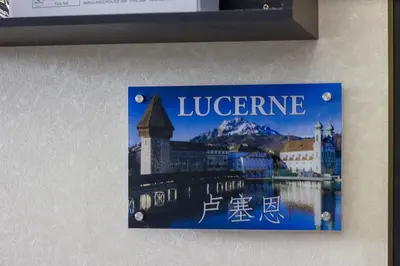 a sign on a wall with a picture of lucerne at USM Designer Dwell in George Town