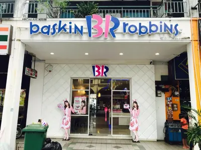 two girls in pink dresses standing outside a store at USM Designer Dwell in George Town