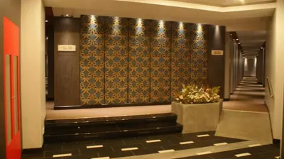 a hallway with a stairway with a wall with a wallpaper at De Hotel Ipoh in Ipoh