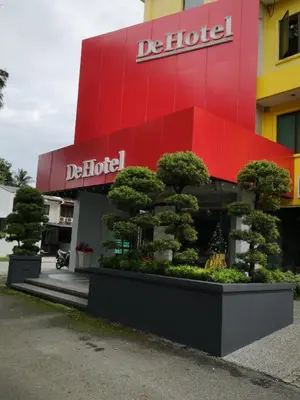 a building with a sign that reads detroit with trees in front at De Hotel Ipoh in Ipoh