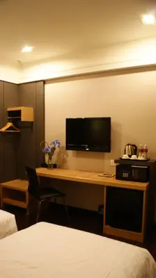 a hotel room with a desk with a computer monitor at De Hotel Ipoh in Ipoh