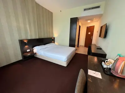 a bedroom with a bed in a hotel room at SSL Traders Hotel in Taiping