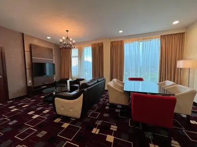 a hotel room with a dining table and chairs at SSL Traders Hotel in Taiping