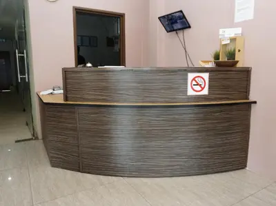 a wooden counter with a no smoking sign on it at Hotel Seri Pauh in Perai