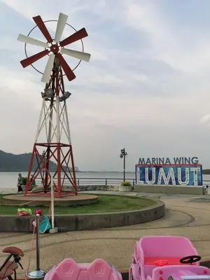 a pink car parked in front of a windmill at Lumut Titi Panjang Apartment in Lumut