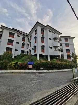 a large white apartment building on the side of the street at Lumut Titi Panjang Apartment in Lumut