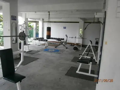a gym with a lot of equipment in a room at Lumut Titi Panjang Apartment in Lumut